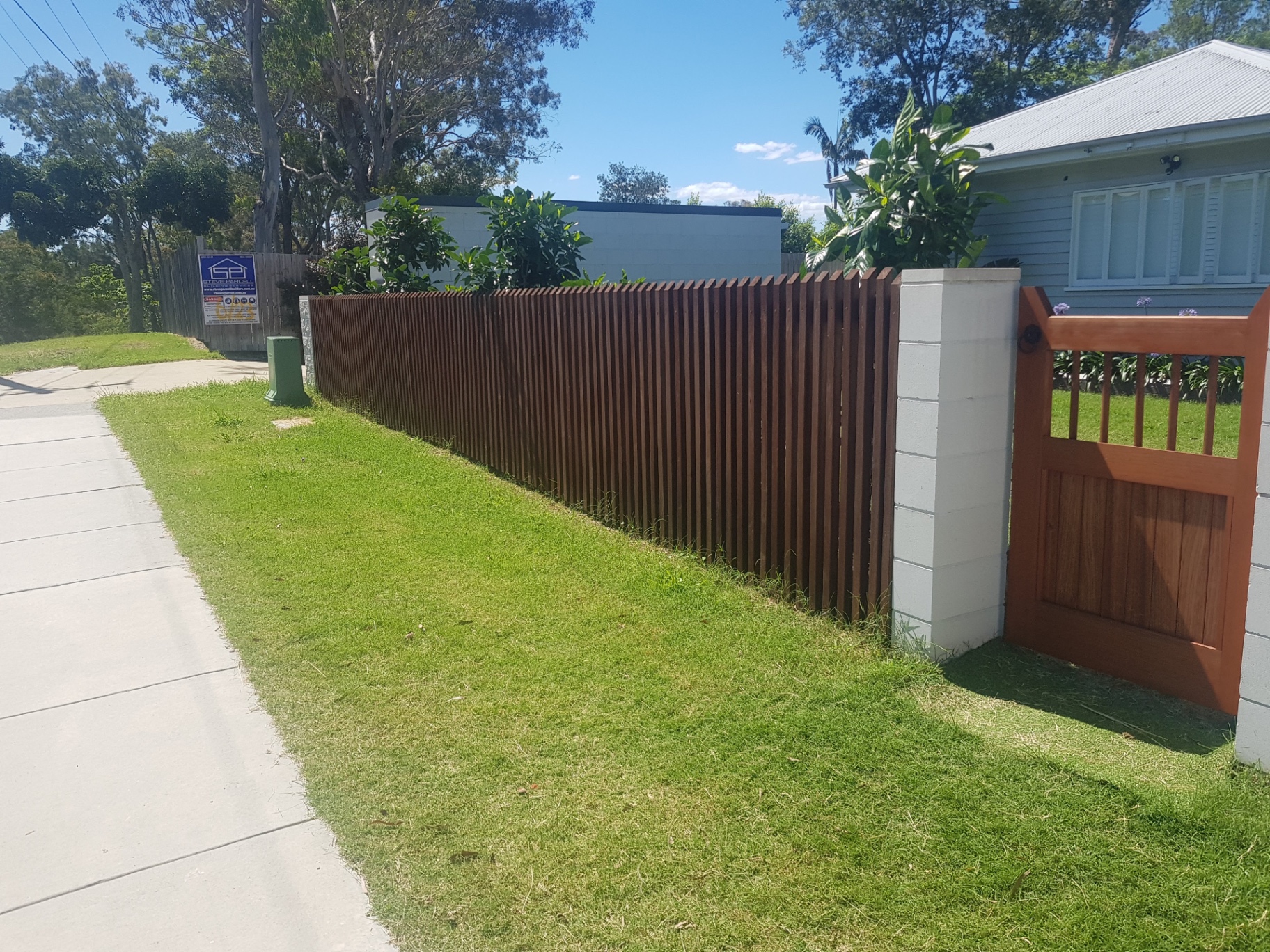 Hardwood timber slat front fence with matching gate built by Ridgeback Fences.